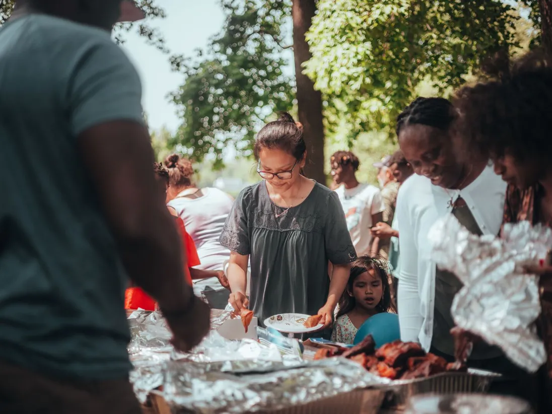 Families sharing food together at an outdoor community gathering