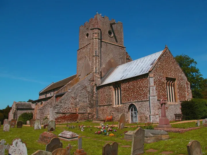 A church and churchyard under a clear blue sky