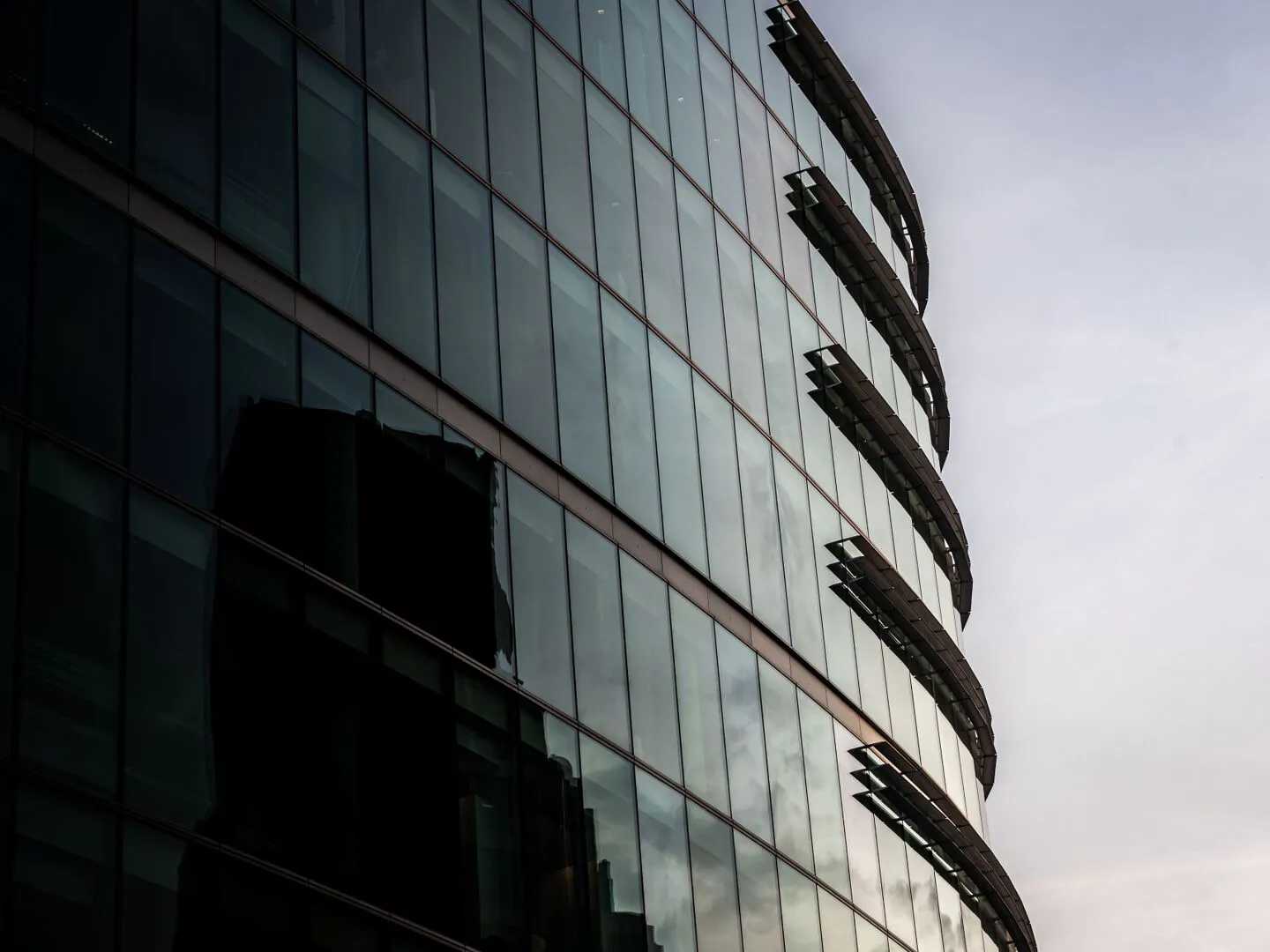 Contemporary glass office building in London reflecting the cityscape