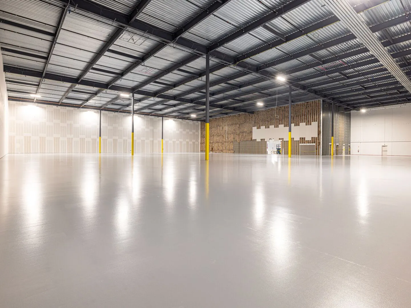 Empty modern warehouse interior with polished concrete floor