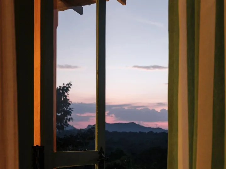 Sunset seen through the balcony doors at Peacock Hill Sigiriya