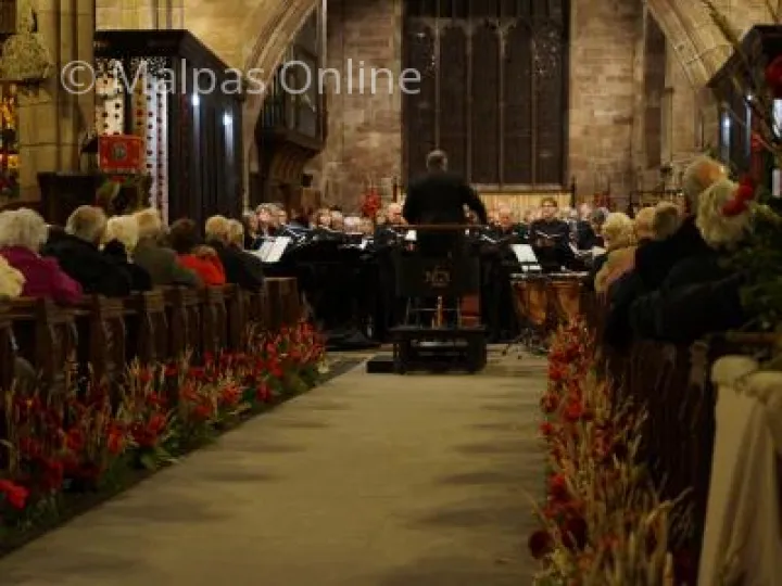 John Naylor conducting the orchestra at The Armed Man Concert