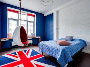 Stylish bedroom with Union Jack rug, hanging chair