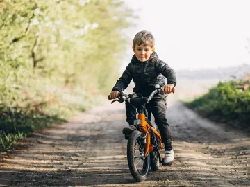 Little boy on bicycle in park