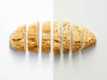 Freshly baked whole wheat bread sliced on a white 