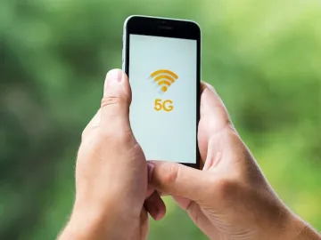 Phone with 5g on screen held in hands