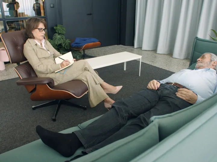 A therapist taking notes while a patient lies on a