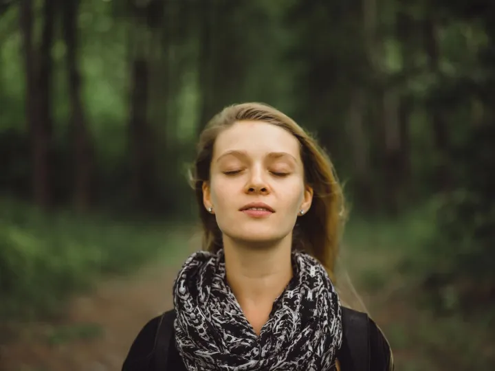 girl with long hair walks through the forest.