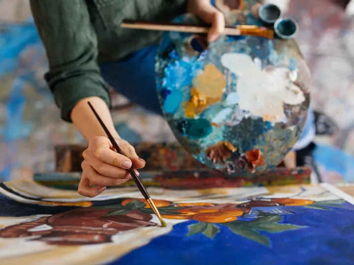 Top view of attractive woman hands drawing amazing picture o