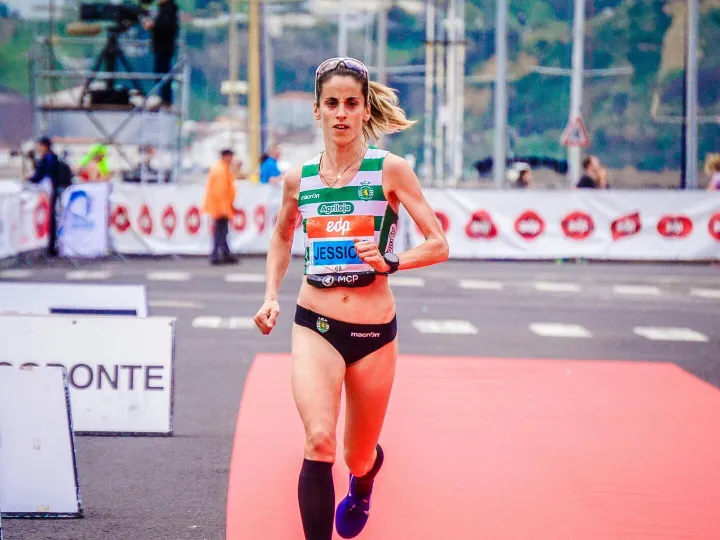 Focused female athlete crossing the finish line