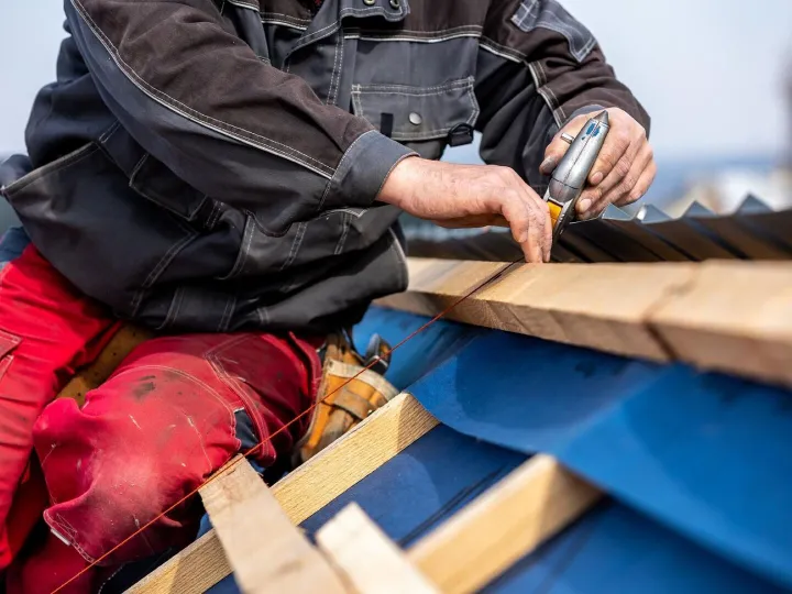 Craftsman or construction worker install a new roof roofing 