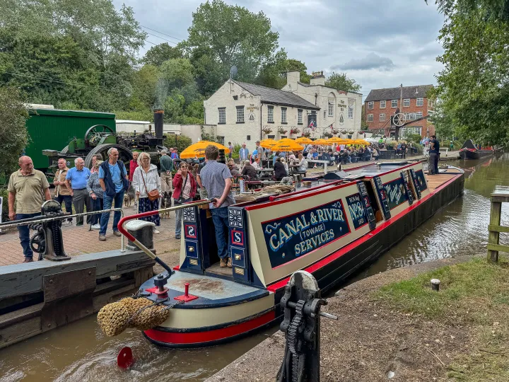 A narrowboat passes through a lock at Audlem Wharf