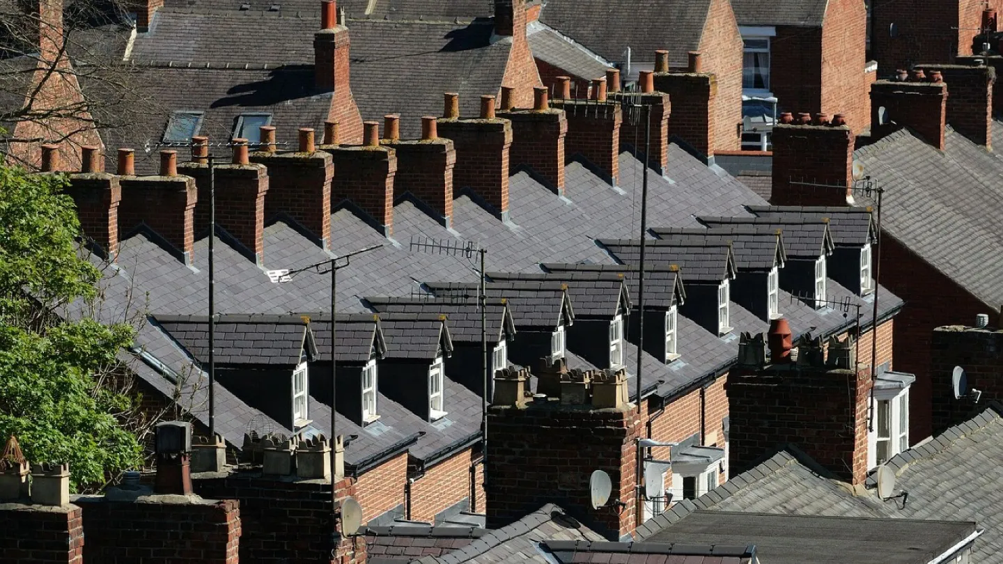 Red-brick terraced rooftops and chimney pots